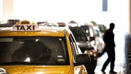 A cabdriver awaits passengers at Bush Intercontinental Airport, where services like Uber can now operate. ﻿