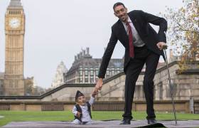 Chandra Bahadur Dangi, from Nepal, the shortest adult to have ever been verified by Guinness World Records, poses for pictures with the world's tallest man Sultan Kosen from Turkey, during a photocall in London on Nov. 13, 2014, to mark Guinness World Records Day.