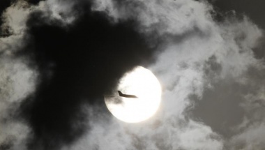 A passenger aircraft is silhouetted against the rising sun after taking off from New Delhi's Indira Gandhi International Airport April 3, 2012. REUTERS/B Mathur