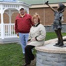  Bob Seibel and Nancy Evans pose for a picture in the growing Remembrance Garden at Hampton High School.