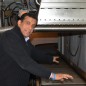 Dr. Suresh D. Pillai shows where food and other materials pass along an automated conveyor belt to be sanitized in moments by a 10 million-electron volt eBeam. Pillai is a Texas A&M AgriLife Research scientist and director of the National Center for Electron Beam Research, College Station. (Texas A&M AgriLife Communications photo by Robert Burns)