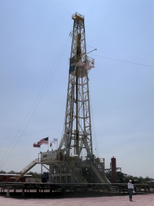 A Chesapeake Energy Corp. worker stands beside a Chesapeake oil drilling rig on the Eagle Ford shale near Crystal City, Texas, June 6, 2011. 