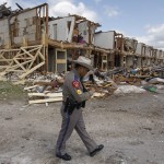 Texas Department of Public Safety Sergeant Jason Reyes walks past the site of an apartment complex destroyed by the deadly fertilizer plant explosion in West.
