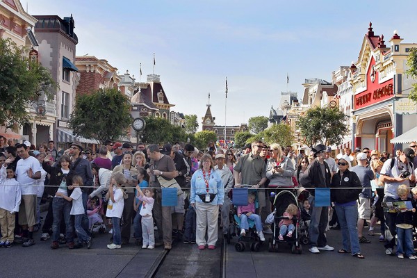 Visitors on Main Street U.S.A. await Disneyland’s opening after its sprucing up by the night crew, upholding founder Walt Disney’s vision of an immaculate land, free of the litter and grime of the outside world.