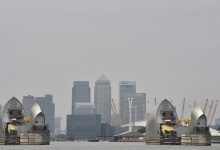 The Thames Barrier is seen across the River Thames with the Canary Wharf business district seen in the background in London September 7, 2014.  REUTERS/Toby Melville 