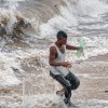 A man runs away from the waves in Gibara, Holguin province, Cuba on August 25, 2012, during tropical storm Isaac.