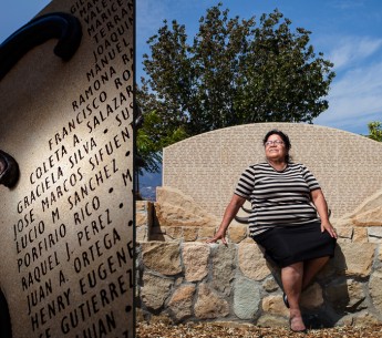 Graciela Silva worked for nine years in the fields harvesting lemons, lettuce, cucumbers, and strawberries. She sits in front of a monument, that includes her name, honoring local farmworkers in Santa Paula, CA.
