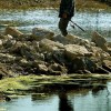 A fisherman walks from his fishing spot at the Tonkawa Falls area 10 January 2004 in Crawford, Texas. A new bill would require lakes with mercury contamination to post warning signs to fishermen.