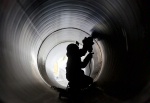 Date: 04/26/2012 Location: Lower Saxony, Germany Description: A worker cleans up at Syke during construction of the North European Gas Pipeline (NEL), a weld in a pipe. By the total number of 440-kilometer gas pipeline from Ludmin Mecklenburg Rehden in Lower Saxony to the future, natural gas from Siberia to be sponsored by the laid in the Baltic Nord Stream pipeline to Germany.  © AP Image/Foto: Joerg Sarbach/dapd