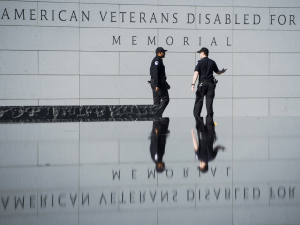 U.S. Capitol Police officers walk past the American Veterans Disabled for Life Memorial in Washington on Tuesday.