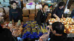 Volunteers pass out fresh vegetables for a Thanksgiving meal at the Alameda Food Bank in Alameda, Calif., in 2009. The percentage of Americans who report struggling to afford food has remained stubbornly near recession-era highs.