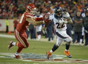 The Broncos' C.J. Anderson is chased by the Chiefs' Josh Mauga in the second quarter on Nov. 30, 2014.