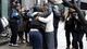 Two women hug near the site of Eric Garner's death