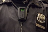 A New York Police Department officer demonstrates how to use and operate a body camera during a press conference on Dec. 3, in New York