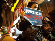 NEW YORK, NY - DECEMBER 03:  Demonstrators hold an impromptu vigil for Eric Garner, the man killed by a police officer in July using a chokehold, outside the beauty salon where the confrontation took place on December 3, 2014 in the Staten Island borough of New York City. A grand jury declined to indict New York City Police Officer Daniel Pantaleo in Garner´s death.  (Photo by Andrew Burton/Getty Images)