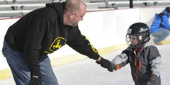 Four-year-old jackson Davis gets a helping had from his father Bryan at the Winterfest ice skating rink at Copper River park in Pennsauken. ( RON TARVER / Staff Photographer ) November 28, 2014