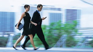 A businessman and businesswoman walking