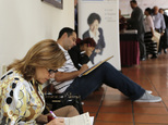 In this Oct. 22, 2014 photo, job seekers fill out job applications at a job fair in Miami Lakes, Fla. The Labor Department releases employment data for November on Friday, Dec. 5, 2014. (AP Photo/Alan Diaz)