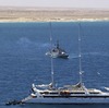 Zodiac commando boats arrive at the rear of the French luxury yacht Le Ponant, whose crew was held hostage by pirates, in April 2008. The French navy frigate Le Commandant Bouan is seen in the background, off Somalia's coast.