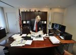 Mayor David Martin rearranges papers on his desk at the Stamford Government Center in Stamford, Conn., on Thursday, Dec. 4, 2014.