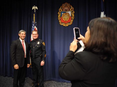 City councilman Ron Nirenberg, left, poses with new interim police chief Tony Treviño as Lorraine Pulido takes a picture after a press conference on Friday, December 5, 2014. Photo: Billy Calzada, San Antonio Express-News /  San Antonio Express-News