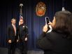 City councilman Ron Nirenberg, left, poses with new interim police chief Tony Treviño as Lorraine Pulido takes a picture after a press conference on Friday, December 5, 2014.