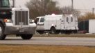 Police investigate the cash site where a man was hit by an 18-wheeler.