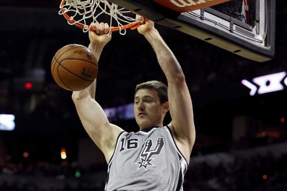 San Antonio Spurs' Aron Baynes dunks between Brooklyn Nets' Deron Williams (left) and Brooklyn Nets' Joe Johnson during second half action Saturday Nov. 22, 2014 at the AT&amp;T Center. The Spurs won 99-87.