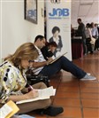  Job-seekers fill out job applications at a job fair in Miami Lakes, Fla., in October. The U.S. Labor Department said employers added 321,000 jobs in November, the biggest burst of hiring in nearly three years.
