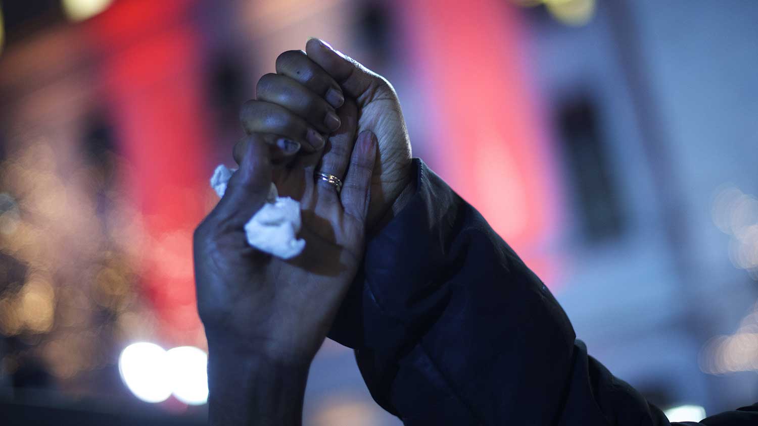<p>Demonstrators clutch hands while gathering in Philadelphia to protest the grand jury decision during a Christmas Tree lighting ceremony at City Hall on Dec. 3, 2014.</p>

