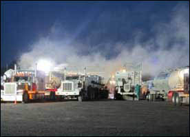 Silica dust clouds from delivery trucks loading into sand movers Photo credit: NIOSH
