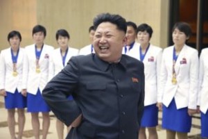 North Korean leader Kim Jong Un smiles as he meets athletes who won gold medals at the 17th Asian Games and recent world championships alongside their coaches