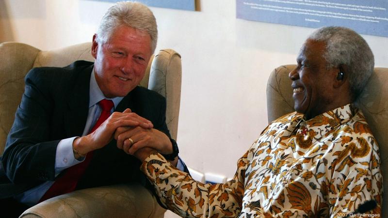 Former President Bill Clinton embraces former South African President Nelson Mandela following remarks by Clinton during a visit to the Nelson Mandela Foundation July 19, 2007  in Johannesburg, South Africa.