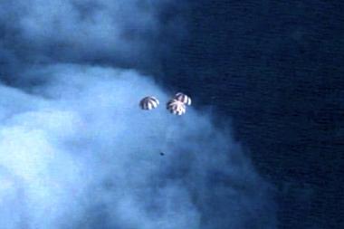 In this image provided by NASA, the Orion spacecraft descends before splashing down in the Pacific Ocean, Friday, Dec. 5, 2014, following a dramatic test flight that took it to a zenith height of 3,600 miles and ushered in a new era of human exploration aiming for Mars. (AP Photo/NASA)