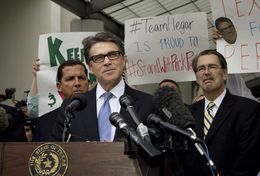 A defiant Texas Governor Rick Perry speaks to supporters after his booking at the Travis County Courthouse on August 19, 2014.