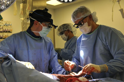 Maj. Jason Pasley, left, and Lt. Col. Jason Williams operated on a wounded man’s arm at Craig Joint Theater Hospital.