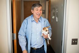 Dr. Orlando Garza walks with a dog that was boarding at his animal hospital on Monday in El Paso. Garza has been a practicing veterinarian since 1982.