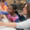 Fatonia Shank, a fourth grade teacher in Warren Township, helps a student with a writing exercise.