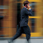 Photo of a business person walking along a city street