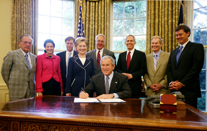U.S. Sen. Bill Nelson, second from right,  joins President Bush, seated, for the signing of a bill Nelson co-authored requiring Internet-based telephone companies provide customers with 9-1-1 emergency service.