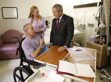 President George W. Bush talks with U.S. Army Brig. Gen. Dr. Charles William Fox, Jr. (Retired) and wife, Jan, of Leesburg, Va. during a visit Tuesday, Sept. 9, 2008, with wounded military personnel at Walter Reed Army Medical Center, in Washington, D.C. General Fox, CEO of Project Hope, was injured by an IED while helping to build a state-of-the-art cancer treatment facility for children in Basra. White House photo by Eric Draper