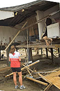 Red Cross worker Margaret Sanner surveys damage to the island less than 48 hours after the passage of Hurricane Ike. Photographer: Dennis Drenner/American Red Cross
