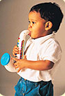 A little boy playing a toy saxaphone.
