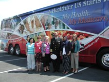 Photo - Admiral John Agwunobi, Assistant Secretary of Health in fron of Medicare bus with members of partnering organizations in Annapolis, MD