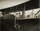 Katharine Wright, wearing a leather jacket, cap, and goggles, aboard the Wright Model HS airplane with Orville, 1915