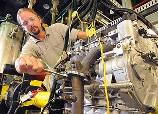 Argonne mechanical engineer Thomas Wallner adjusts Argonne's 'omnivorous engine,' an automobile engine that Wallner and his colleagues have tailored to efficiently run on blends of gasoline, ethanol and butanol