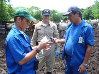 Two veterinarians from the Nicaraguan Ministry of Agriculture and Forestry (left and right) are demonstrating to LCDR Gregory Langham, veterinarian, U.S. Public Health Service (center) a hand-held global-positioning system (GPS) device that they use in epidemiology and surveillance on July 23, 2007.