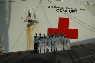 The second team of HHS U.S. Public Health Service Commissioned Corps Officers on the pier next to the USNS Comfort before they departed El Salvador on their way to Perú.