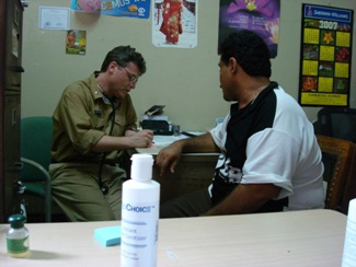 CDR Abraham Miranda, HHS U.S. Public Health Service Commissioned Corps infectious-disease physician, with a patient in Corinto, Nicaragua.