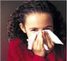 Girl covering her mouth with a tissue